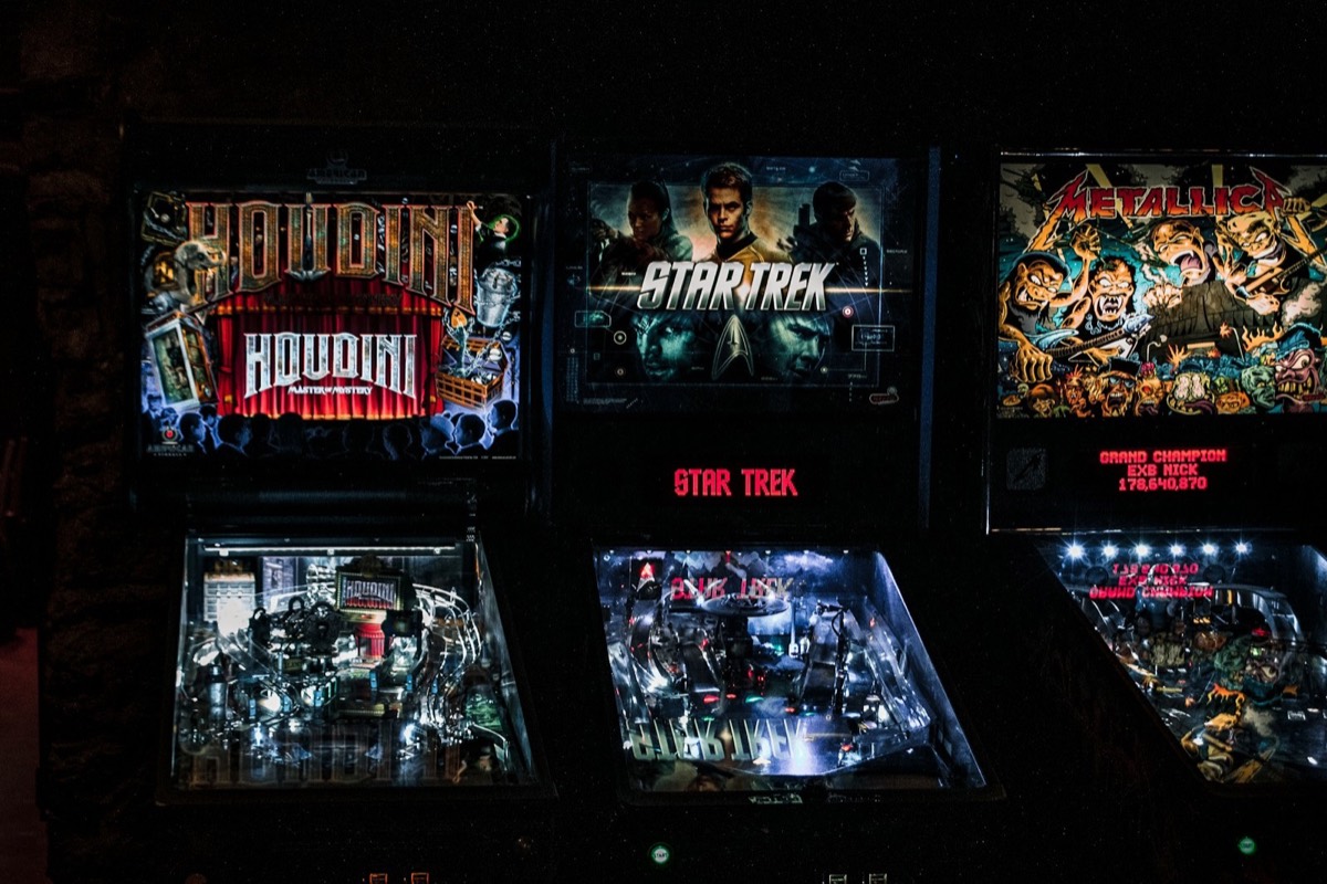 Row of lit-up pinball machines